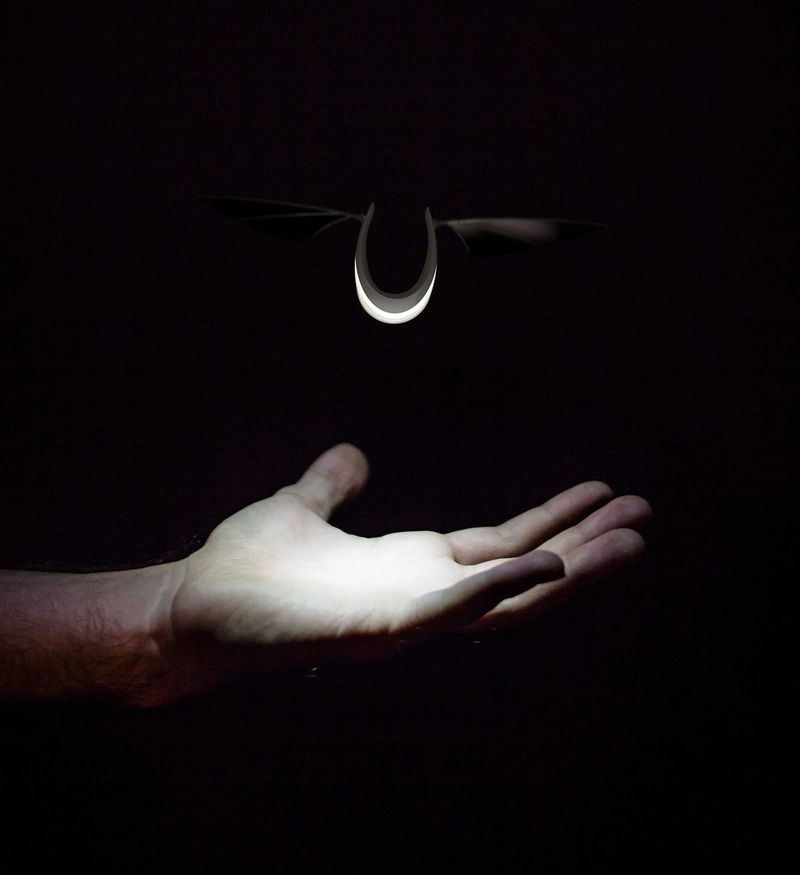An illustration simulating a Flyht lamp hovering an open hand in a dark room.